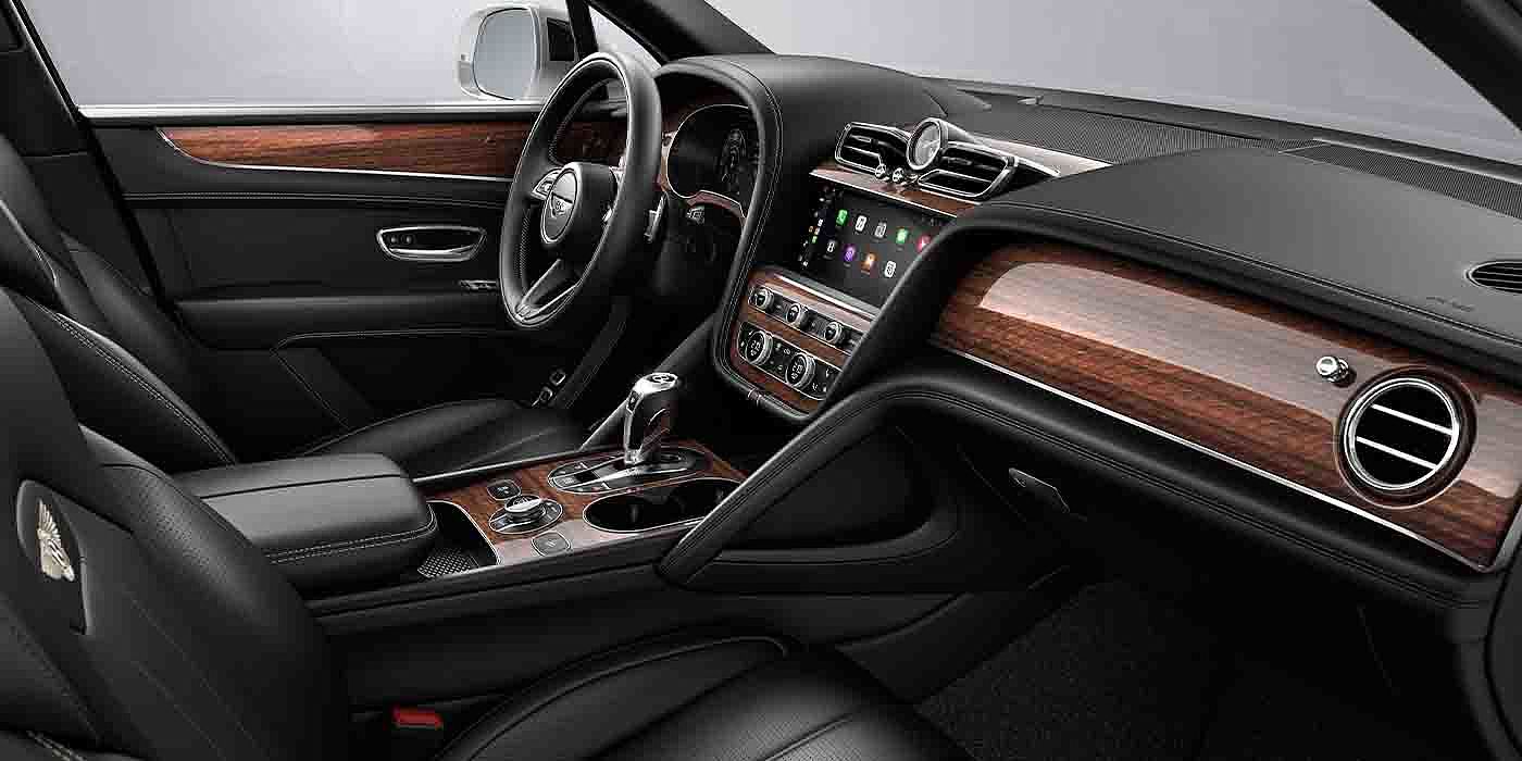 Bentley Chengdu - Gaoxin Bentley Bentayga EWB interior with a Crown Cut Walnut veneer, view from the passenger seat over looking the driver's seat.